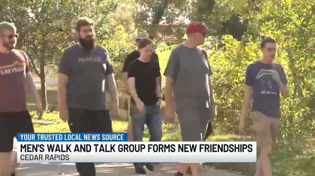 men walk together on a path outdoors
